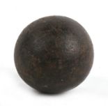 An 18th/19th century cast iron 4lb round shot cannon ball. Approximate diameter 7.5cms (3ins)