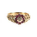 A 9ct gold diamond and ruby cluster ring, approx UK size 'O'.