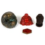 A Chinese red cinnabar lacquer figure in the form of a seated Buddha, 6.5cms (2.5ins) wide; together