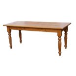 A modern pine rectangular kitchen table on turned legs, 183cms (72ins) long.