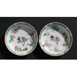 A pair of Kangxi period famille vert saucer dishes decorated with flowers, double circle and