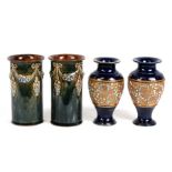 A pair of Royal Doulton stoneware sleeve vases, 15cms (8ins) high; together with a pair of Royal