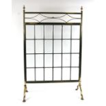 A brass fire screen set with twenty four rectangular bevelled glass panels, 52cms (20.5ins) wide.