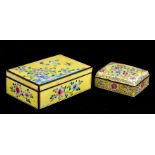 A Chinese enamel box decorated with flowers and insects on a yellow ground, 16cms (6.25ins) wide;