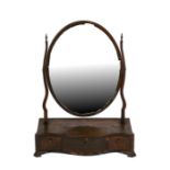 A 19th century mahogany toilet mirror, the oval mirror above three short drawers, 45.5cms (18ins)