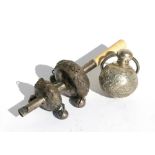 A 19th century Chinese white metal babies rattle decorated with prunus with bells and a whistle;
