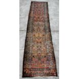 A Turkish Ushak woollen hand knotted runner with all over floral design on an ivory ground,