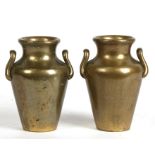 A pair of heavy brass two-handled vases, stamped 'V. Vallepurem Negombo', 9cms (3.5ins) high (2).