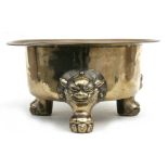 A large polished bronze Chinese censer on three lion mask paw legs, 39cms (15.25ins) diameter.