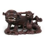 A Chinese carved hardwood fo dog and pup, 20cms (8ins) wide.