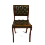 A reproduction mahogany desk chair with leather upholstered buttoned seat and back.