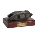 A rare WW1 tank desk ornament mounted on a hardwood base with engraved brass plaque which reads: