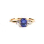 A 14ct gold ring set with a central sapphire flanked by two diamonds, approx UK size 'Q'.Condition