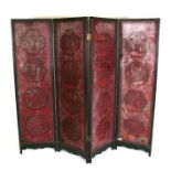 A late 19th century Chinese four-fold cinnabar lacquer screen decorated with figures in landscape