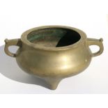 A Chinese bronze twin-handled censer with unusual seal mark to underside, 11cms (4.25ins)