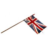 An early 20th century Union Jack flag on its pole. The flag is 42cms (16.25ins) by 76cms (30ins)