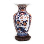 A Japanese Imari vase on a hardwood stand, 31cms (12.25ins) high.