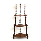 A Victorian walnut four-tier corner whatnot, 62cms (24.5ins) wide.