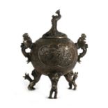 A Chinese bronze censer of globular form decorated with flowers and stylised bird handles and