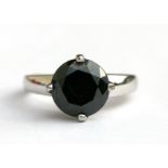 A 9ct white gold ring set with a large black diamond, approx UK size 'N'.