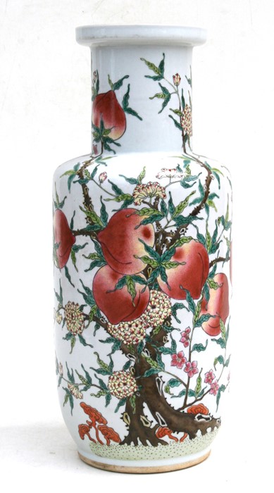 A Chinese rouleau vase decorated with peaches and flowers, 45cms (17.5ins) high.