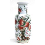 A Chinese rouleau vase decorated with peaches and flowers, 45cms (17.5ins) high.