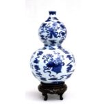 A Chinese blue & white double gourd vase decorated with flowers and precious objects, blue seal mark