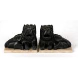 A pair of Chinese soapstone carvings in the form of recumbent lions, 9cms (3.5ins) wide.