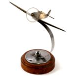 A brass model of the WW2 fighter the Hawker Hurricane with perspex propeller mounted on its chrome