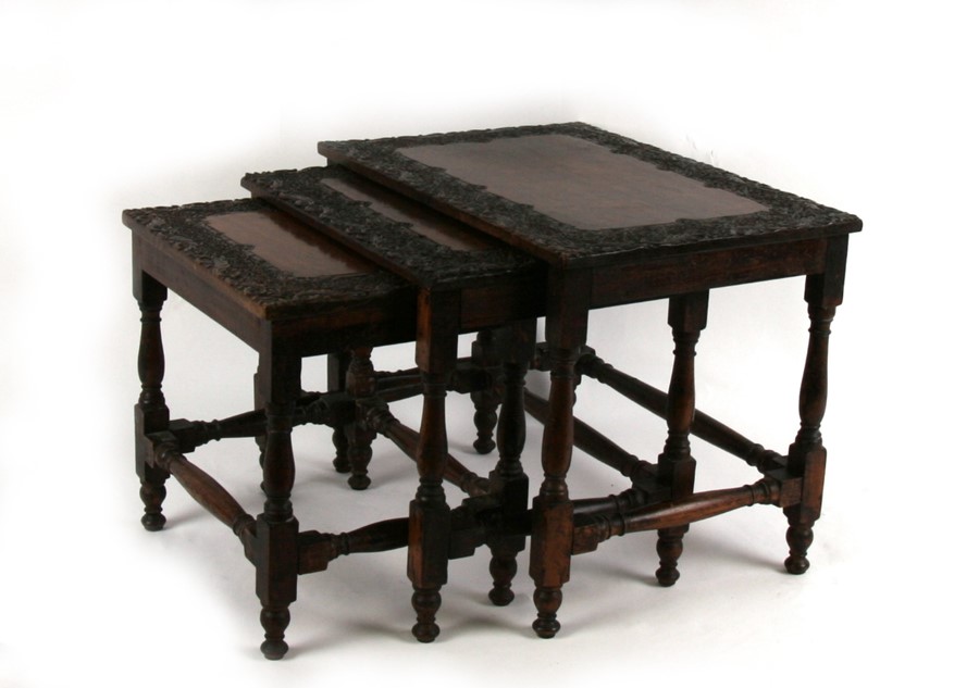 A nest of three Asian profusely carved hardwood tables, probably Burmese, the largest 41cms ( - Image 2 of 2