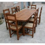 A solid oak refectory table on twin turned supports, 92 by 228cms (36 by 90ins); together with a