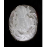 A Chinese carved jade brooch decorated with fruit and foliage, 6cms (2.25ins) wide.