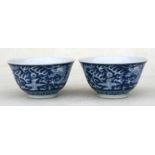 A pair of Chinese blue & white bowls decorated with dragons chasing a flaming pearl, six character