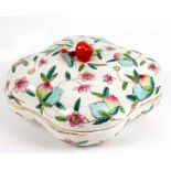 A Chinese box and cover decorated with flowers and peaches and with a peach finial, red square