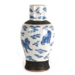 A 19th century Chinese crackle glaze vase decorated with shishi dogs amongst clouds, incised mark to