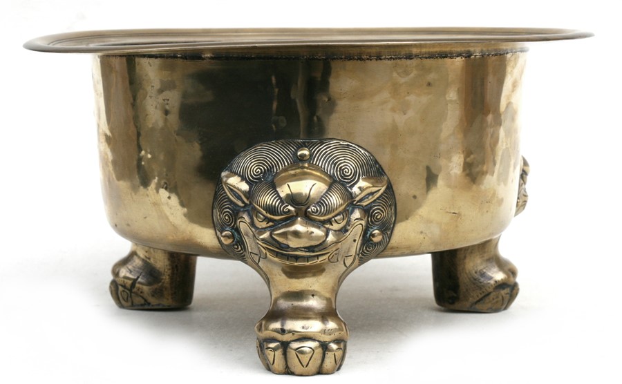 A large polished bronze Chinese censer on three lion mask paw legs, 39cms (15.25ins) diameter.