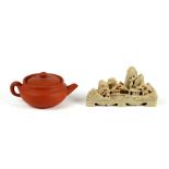 A Chinese yixing miniature tea pot. 5cm (2 ins) high together with a soapstone carving depicting a