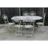 A white painted metal garden table and six matching chairs, the table 160cms (63ins) wide.