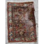 A Caucasian hand knotted rug with geometric design on a beige ground, 139 by 98cms (54.7 by 38.