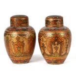 A pair of Persian / Indian lacquered vases and covers decorated with stylised flowers, 10cms (