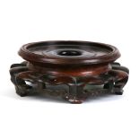A large Chinese hardwood vase stand, 19cms (7.5ins) diameter.
