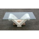 A modern design coffee table, the rectangular glass top on a faux marble stand, 120cms (47.25ins)