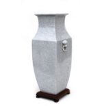 A Chinese crackle glaze tapering square form vase with lion mask handles on a hardwood stand,