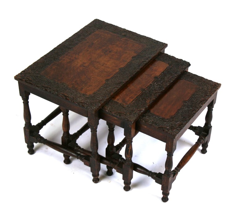 A nest of three Asian profusely carved hardwood tables, probably Burmese, the largest 41cms (