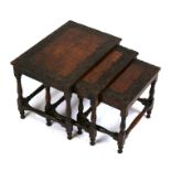 A nest of three Asian profusely carved hardwood tables, probably Burmese, the largest 41cms (