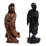 A Chinese boxwood carving in the form of Guanyin holding a vase, 46cms (18ins) high; together with a