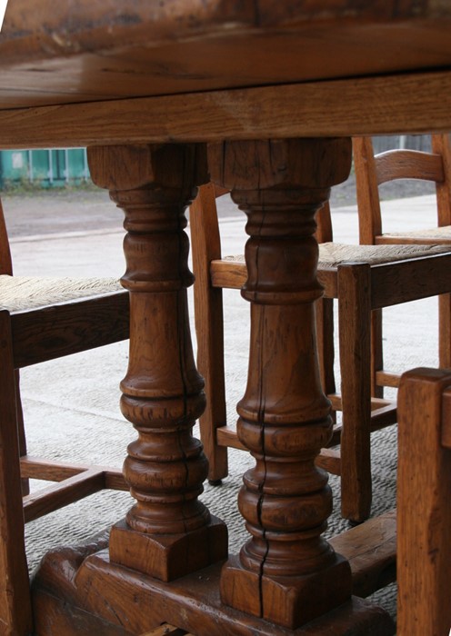 A solid oak refectory table on twin turned supports, 92 by 228cms (36 by 90ins); together with a - Image 4 of 5