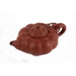 A Chinese Yixing teapot of compressed pumpkin form, 9cms (3.5ins) diameter.