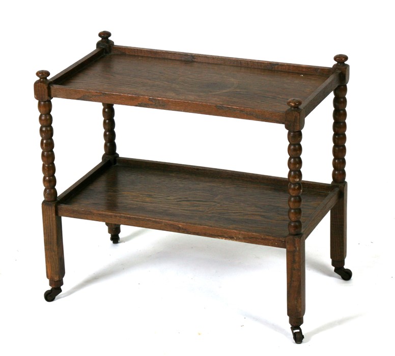 A miniature oak two-tier tea trolley on bobbin turned supports (possibly an apprentice piece)