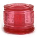 A Chinese Peking ruby glass archers ring box of cylindrical form decorated with a landscape and